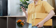 © Natee Meepian - Online Shopping. Carrying multiple packages while checking smartphone.