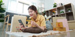 © Natee Meepian - E-commerce Experience. Young woman enjoying online shopping with credit card and smartphone.