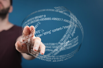 Person touches a sphere of digital code representing internet data and technology.