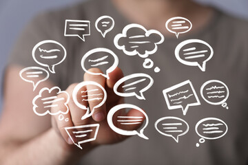 Person interacting with digital chat bubbles, communication concept.