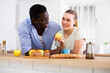 © caftor - Wife and husband having breakfast in modern kitchen at home