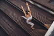 © BullRun - Smiling woman in high lunge yoga pose with arms raised overhead. Conceptual stock photo symbolizing energy, positivity, focus, empowerment, and mindful digital fitness lifestyle.