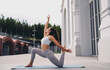 © BullRun - Focused woman practicing yoga low lunge quad stretch, arm lifted upward. Conceptual stock photo symbolizing mindfulness, empowerment, flexibility, resilience, and digital wellness culture.