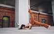 © BullRun - Athletic woman practicing yoga chin stand variation with one leg lifted. Conceptual stock photo symbolizing resilience, empowerment, focus, flexibility, mindfulness, and digital wellness culture.