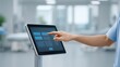 © Preeyanuch - A person interacts with a touchscreen tablet in a modern, clinical environment.