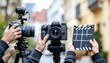 © Nurdin - Film crew holding cameras and clapperboard on location, preparing to shoot a scene.