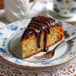 © Welington Campelo  - A slice of bolo de cenoura with chocolate topping served on a dessert plate with fork