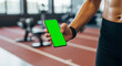 © SABq - Smartphone fitness app mockup in athlete’s hand, perfect for health tracking, workout branding, sports technology presentation, mobile interface showcase, and active lifestyle promotion