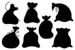 © Mirikiteki - Black silhouettes, shadows of new year bags. Set of simple full Santa Claus gift sacks. Christmas gift bags.