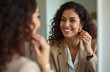 © Raisa - Businesswoman smiles while putting pearl earring in her ear, preparing for work. She looks in mirror, checking appearance. Elegant, confident female in business wear gets dressed indoors.