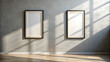 © HAJERA - Two blank frames on a grey wall indoors
