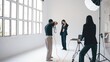 © DMegias - Photographer taking pictures of fashion model in professional studio