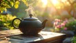 © Design - Steaming teapot on wooden table, sunlit garden backdrop
