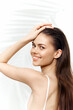 © VICHIZH - Young woman smiling with long hair, showcasing a fresh and vibrant look against a light background, perfect for beauty and lifestyle themes.