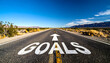 © EPDICAY - Road to achievement and ambition with word GOALS and directional arrow leading ahead.