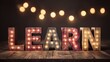 © Keo - A wooden sign with the word 'LEARN' illuminated with lights against a dark background.
