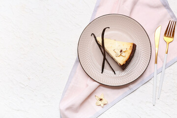 Wall Mural - Plate with piece of sweet vanilla cheesecake on white background