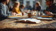 © john - A group of friends actively discusses their thoughts and insights while surrounded by open Bibles and notebooks on a wooden table during a study session