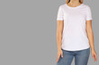 © Atlas - Woman models a simple white t-shirt with jeans for display