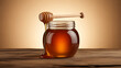 © lisolaci - A jar of honey with a wooden dipper drizzling honey onto a rustic wooden surface