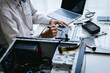 © mojo_cp - technician maintains computer PC hardware in a technical workspace