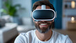 © siraphol - Man wearing VR headset smiles while exploring virtual world, showcasing excitement and wonder