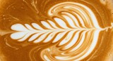 Stunning latte art pattern captures rich coffee aroma and creamy texture, perfect for cafes.