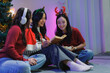 © crizzystudio - Young asian women reading book celebrating christmas