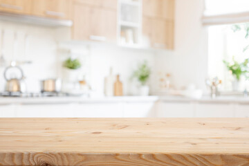 Wall Mural - Empty wooden table for food presentation with bright blurred kitchen interior background