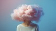 © TPS Studio - A surreal image featuring a person's head replaced by a fluffy pink cloud against a blue background, evoking a dreamy, whimsical atmosphere.