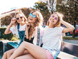 © halayalex - Portrait of three young beautiful smiling hipster female in trendy summer clothes. Sexy carefree women posing on the street background.Positive models having fun in sunglasses.Hugging
