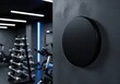 © Aurora Aesthetics - A black round sign mockup on a dark wall in a modern gym a powerful and energetic signage for a fitness brand or workout space logo