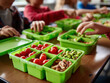 © Maksim - Brightly colored bento boxes filled with healthy snacks spark joy as students discuss lunch at their desks