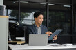 © NINENII - Businessman using laptop computer in office. Happy man, entrepreneur, small business owner working online.