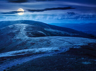 Wall Mural - scenery mountain ridge in late summer at night. outdoor adventure. alpine landscape of mountain range in full moon light. grassy meadows and rolling hills. travel background. beautiful view