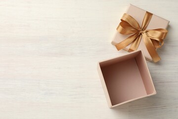 Wall Mural - Open gift box with beautiful lid on white wooden table, top view. Space for text
