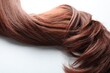 © New Africa - Auburn hair strand on white background, closeup