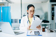 © Nuttapong punna - Asian female doctor using digital tablet to review medical data in hospital office. Concept of healthcare innovation, telemedicine, smart diagnosis, and real people professionalism.