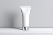 © karmila - White tube of cosmetic product on a white surface