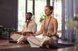 © Rido - Young couple practice meditation together