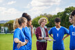 © Rido - Coach explaining game plan to teens players in the field