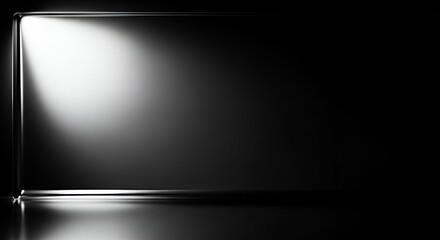 Sleek, reflective glass surface with dramatic light and shadow creating a modern, sophisticated background for product display or design concepts.