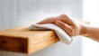 © Anat art - Hand Cleaning a Wooden Shelf With a Cloth in a Bright and Minimalistic Room