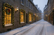 © Jafree - Winter street of old town with festive lights and snow-covered aesthetic on a quiet evening. concept of holiday atmosphere, vintage architecture, seasonal decoration