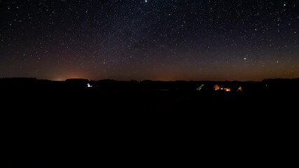 Wall Mural - Epic day to night transition over a vast rural field, with stars emerging as light fades dusk, twilight, stars