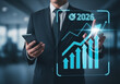 © su - Businessman pointing at upward arrow and 2026 target goal icon, symbolizing future growth, business strategy, financial success, and goal achievement planning
