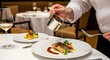 © Shil - Chef plating a dish with sauce in a fine dining restaurant setting beautifully presented