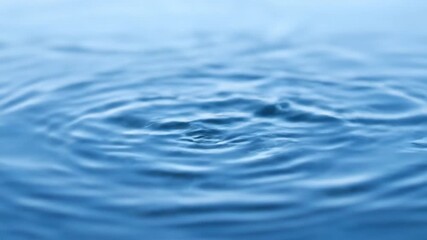 Wall Mural - Timelapse of ice hail pellets falling onto a calm water surface, creating ripples and melting hail, pattern, rapid
