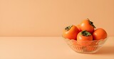 Fruit in a Glass Bowl on a Vibrant Orange Background with Copy Space
