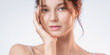 © Buyanskyy Production - Radiant Woman With Clear Skin and Glossy Lips Touching Face Gently